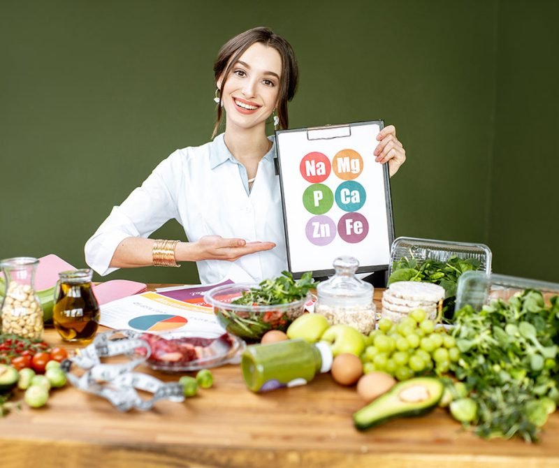 dietitian-with-vitamin-sheme-at-the-table-full-of-resize.jpg